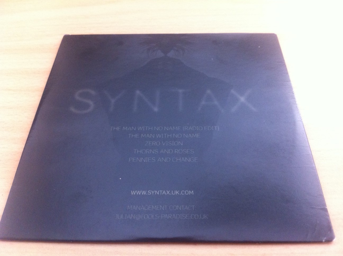 Back cover of Syntax's Tripolar